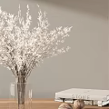 Clear Glass Vase With White Decorative Branches And White Book On Light Gray Wall
