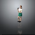 Red Haired Woman In White T-Shirt With Colorful Graphic Green Skirt And Black Shoes Holding Smartphone