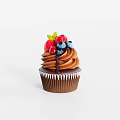Delicious Chocolate Cupcake Topped with Fresh Raspberries Blueberries and Mint Leaf