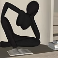 Black Abstract Human Figure Sculpture in Sitting Posture with Open Book and Stacked Books Indoor