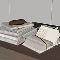 Stacked Books With Leather Pouch And Open Book On Wooden Table