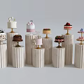 Shop Window Display With Various Cakes And Desserts On White Pillar Stands