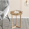 Golden Tray Top Side Table With Books Next To Gray Chair On Light Wall Gray Floor