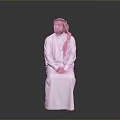 Man In Traditional White Robe With Pink Headscarf Sitting On Gray Background