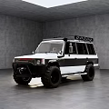 White and Black Off Road Vehicle With Roof Rack and Large Tires in Indoor Setting