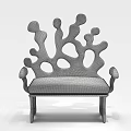 Abstract Shaped Sofa Featuring Wooden Structure Irregular Holes and Curved Design with Floral Cushion