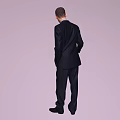 Man in dark suit white shirt and tie standing naturally against light purple background