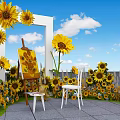 Floral Display With Sunflowers White Frame Easel And White Chair Under Blue Sky