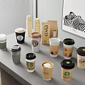 Starbucks Coffee Cups With Various Designs And Paper Lids On Table 3d model