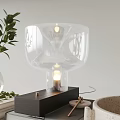 Modern Transparent Glass Table Lamp With Black Base And Green Plant Decor