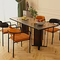 Dining Table Set With Orange Padded Seats Black Frame Chairs Textured Top And Fruit Bowl