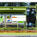 Green Bus Shelter With Colorful Advertisement Boards Trees And People Waiting