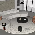 Modern Curved Light Colored Sofa With Accent Pillows And Black Round Coffee Table Set