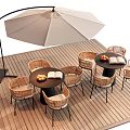 Outdoor Table with Wicker Chairs and Patio Umbrella on Wooden Deck with Fruit and Book