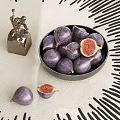 Ceramic Bowl Filled With Fresh Purple Figs On Light Tablecloth With Black Geometric Patterns