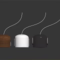 Three Compact Brown White Black Speakers with Circular Drivers on Stands Dark Background Reflection