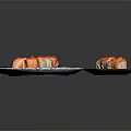 Sliced Sushi Rolls On Blue White Wave Plate With Chopsticks Wasabi And Black Plate Roll