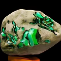 Natural Stone with Green Accents Placed on Wooden Decorative Display Base