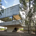Modern Vacation Rental Building With Concrete Cantilevered Design Surrounded By Trees And Large Windows