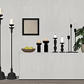 Black Candle Holders With White Candles On Console Table With Fruit Bowl And Monstera Plant
