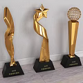 Golden Trophy Awards With Various Designs And Black Bases For Ceremonies