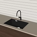 Black Kitchen Sink With Modern Curved Faucet On Light Countertop Against Vertical Striped White Wall