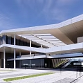 Contemporary Qingtian Performing Arts Center Exterior With Glass Curtain Wall And Waterfront Design