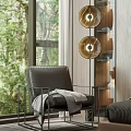 Black Leather Armchair with Gray Blanket near Large Window Golden Pendant Lights and Green Trees
