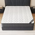 Comfortable White Mattress With Herringbone Pattern On Black Bed Frame And Upholstered Headboard
