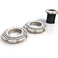 Industrial Metal Ring Components Two Flat Placed And One Upright With Black Base