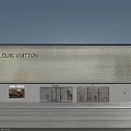 Elegant Illuminated Louis Vuitton Boutique Window Showcase With Unique Golden Patterned Facade At Dusk