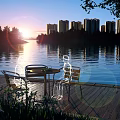 Scenic Lake View At Sunset With Wooden Deck Table Chairs And High Rise Buildings