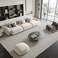 Modern Cream Sofa And Round Black Coffee Table Set With Striped Rug And Footstool