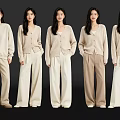 Five Women In Neutral Tone Knit Cardigans And Wide Leg Pants Standing In A Row
