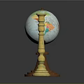 Vintage Globe With Brown Base And World Map Next To Golden Ornate Candle Holder
