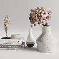 White Speckled Decorative Vase With Dried Flowers And Golden Sculpture On Stacked Books Home Decor
