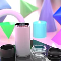 White Cup With Dark Lid Surrounded By Colorful Geometric Shapes On Shiny Surface