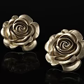 Two Golden Rose Sculptures With Intricate Carving On Black Background And Reflection
