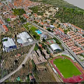 Modern Town Aerial View With Green Spaces Buildings And Sports Field