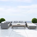 Gray Wicker Outdoor Sofa Set with Coffee Table Green Shrubs and Ocean View