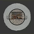 Outdoor Circular Stone Fire Pit With Burning Wood And Metal Grill