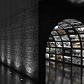 Tunnel of Screens Displaying Black and White Photos with Years and Person Walking