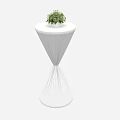 White Tapered Table With Round Top And Green Potted Plant Decoration