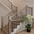 Wooden Staircase With Black Metal Railings In Modern Interior With Green Plant