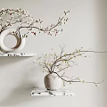 Blooming Branches in White Vases on Two Marble Shelves Against Light Colored Wall