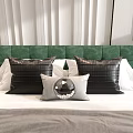 Textured Black And Light Gray Accent Pillows With Round Decor On Green Tufted Headboard Bed