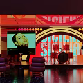 Signature Bar with Large Screen Drum Set Purple Chairs and Vibrant Lighting Ambiance