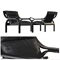 Two Modern Black Leather Lounge Chairs With Metal Frame Design