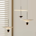 Modern Three Minimalist Pendant Lights With Sleek White Shades And Black Metal Frames