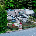 Detached Villa In Wooded Surroundings With Gray Roof Blue Exterior And Front Garden Parking